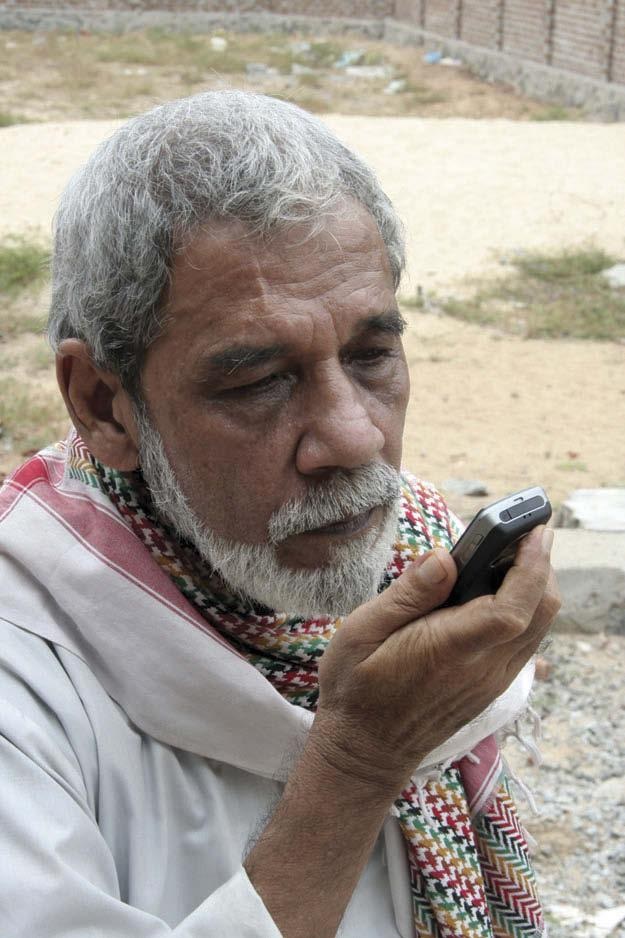 Makkattar using cellphone to transmit curative blessings